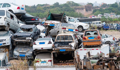 A pile of abandoned cars on junkyard