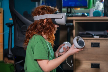 redhead teen girl at home in living room put on vr helmet to enjoy virtual reality online game...