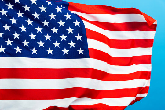 American flag waving on blue background
