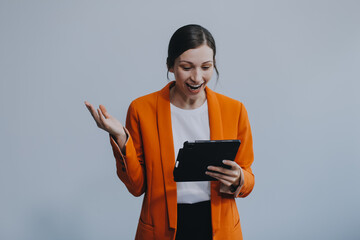 Smiling caucasian young woman girl freelancer student using digital tablet, having idea, pointing...
