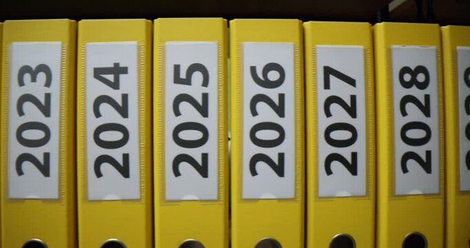 Time lapse of yellow folders with annual labels