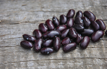 beans on wooden background. black beans closeup on wooden background
