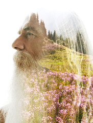 A profile double exposure of an old man merged with a photo of nature
