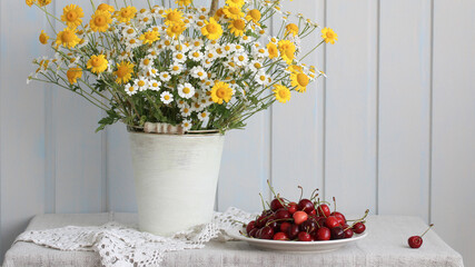 rural still life with daisies and cherries, summer composition. the interior of the cottage.