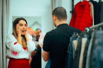 Woman Surprised by her Boyfriend with New Clothes. Cheerful girlfriend being surprised by the...