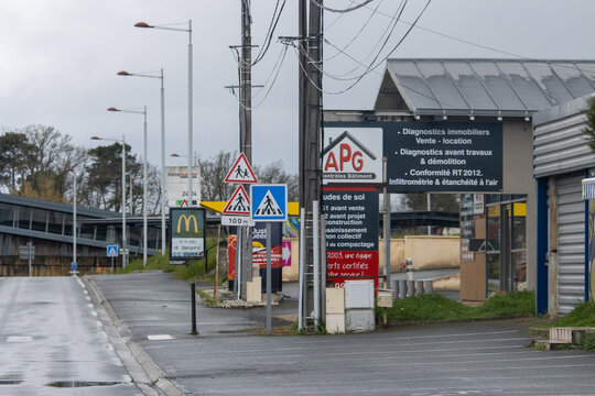 France, 01 April 2024: Commercial Area with Road Signs and Advertising Billboards.