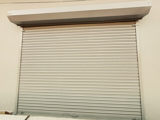 A closeup shot of automatic metal roller door used in factory, storage, garage, and industrial...