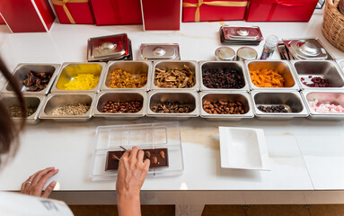 Young woman in the workshop during a lesson on making handmade chocolates and sweets
