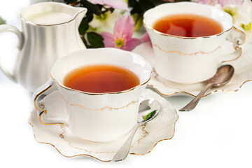 Pretty porcelain teacup with black tea