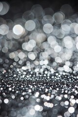 A sparkling silver glitter background with a beautiful bokeh effect exuding luxury and a festive...