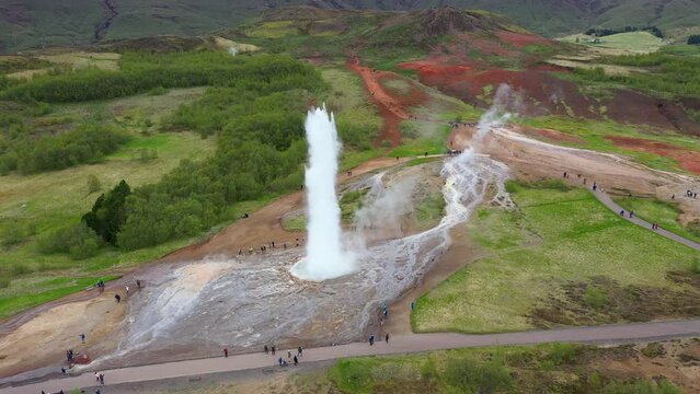 Flying above Strokkur geysir in the moment of eruption, Iceland, aerial slow motion view