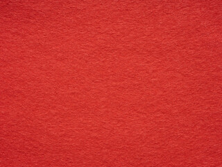 Warm embrace of crimson hues in a detailed close-up of a plush red felt background
