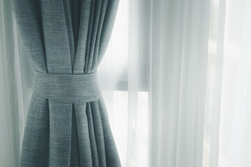 Curtain decotaion on window in home. The soft light filtering through curtains casts delicate that...