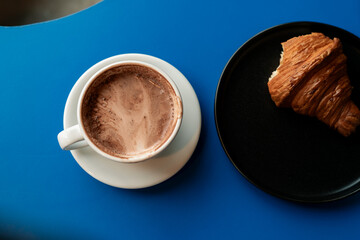 Breakfast with hot cacao and delicious croissant