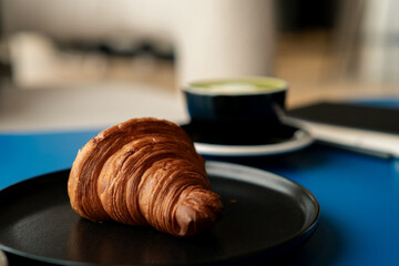Freshly baked butter croissant on a plate