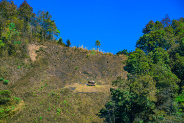 A small hut amidst the complex mountains of Nan Province.