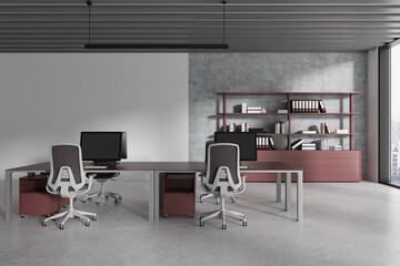 Gray and maroon open space office interior with workspace near blank wall