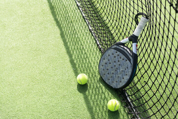 paddle tennis racket, ball. close- up on the racket