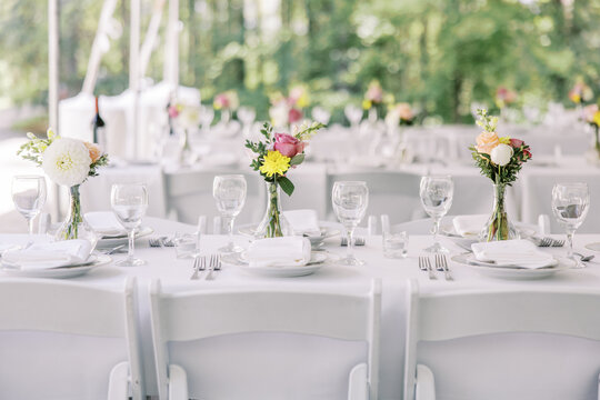 White wedding reception table with floral decor