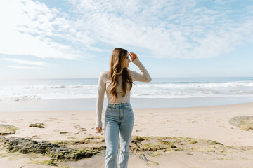 Young woman walking on California beach