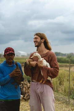 European man with local Indonesian farmer.
