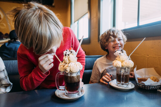 Preteen boys at St. Louis restaurant drinking giant rootbeer flo