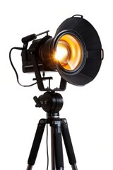 Studio spotlight with bright illumination mounted on a black tripod, isolated on white background.