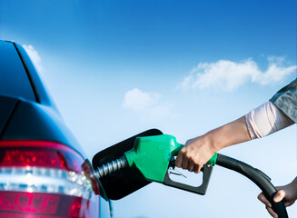 Woman hand refuel the car