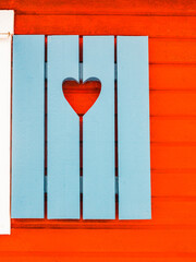 Blue Window Shutters With Heart Cutouts on a Swedish House