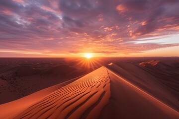 The sun is setting in the sky, casting a warm glow over the vast desert landscape with dunes and sparse vegetation