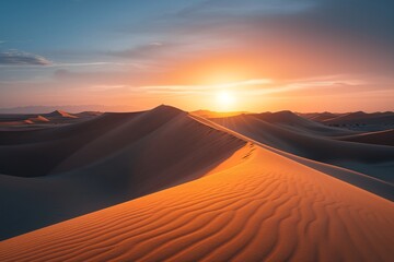 Fototapeta na wymiar The sun dips below the horizon, casting a warm glow over a vast sand dune in the desert