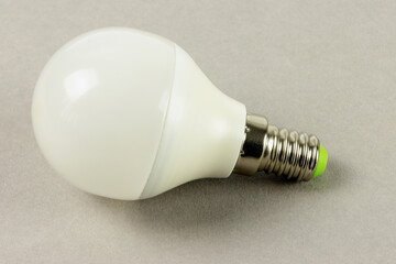 A white LED light on a gray background to illustrate energy efficiency