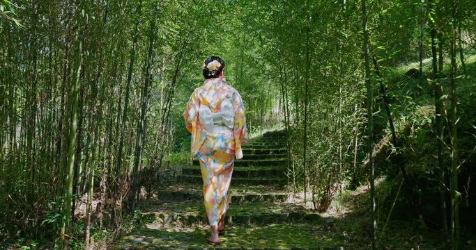 Asian woman try to wear Japanese kimono in the bamboo forest
