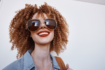 Joyful Beauty: Smiling Woman with Curly Hair Wearing Goggles, Expressing Happiness and Fun