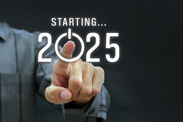 Businessman pressing new year 2025 hologram button