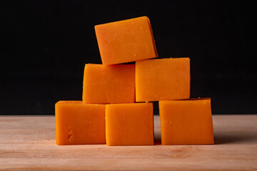 Cubes of orange on the table.