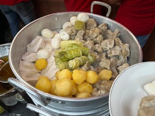 Indonesian traditional dish named Somay or Siomay consists of fish dumpling, egg, tofu, cabbage and potato in a steaming pot