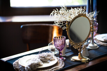 Retro vintage table. Arrangement on the table, antique mirror, plates, vintage mug. Ancient mirror...