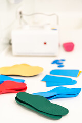 Orthopedic insole. The orthopedist works with the patient. Orthopedic clinic. Choice of insoles in an orthopedic clinic. The orthopedist offers the insole to the patient Foot care