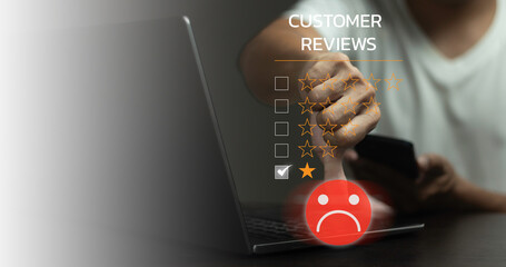 A man is using a laptop with a screen that says Customer Reviews