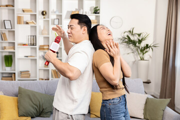 COUPLE SINGING AT HOME, Asian Man Woman Karaoke Fun, Happy Indoor Activity, Togetherness Laughing Lifestyle, Living Room Party