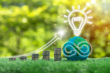 A green planet with a light bulb on it and a stack of coins on the ground