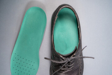 Orthopedic insoles for sports shoes. Treatment and prevention of flatfeet and orthopedic foot diseases. Foot care, feet comfort. Health care, wearing comfortable shoes