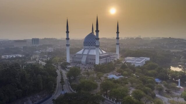 time lapse aerial view of beautiful modern architecture mosque located in selangor, malaysia during sunrise