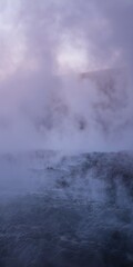 Fototapeta na wymiar Mountain hot spring, close up, steam rising, twilight ambiance