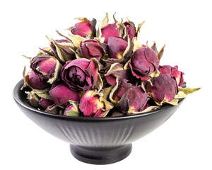 Dried rose buds in a black ceramic bowl isolated on white background