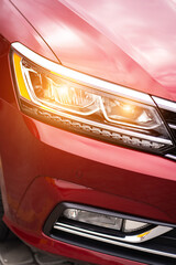 Close up detail on one of the red car taillight modern red crossover car. Exterior detail business automobile.