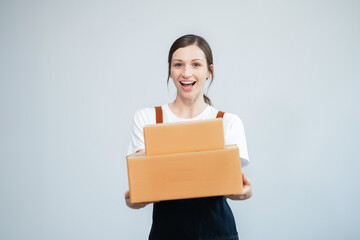 Obraz premium woman start up small business owner writing address on cardboard box at workplace.small business entrepreneur SME or freelance asian woman working with box at home.