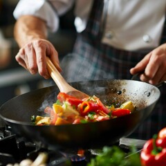 Chef is stirring vegetables in wok