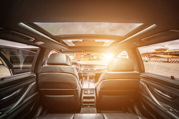 Car inside. Interior of prestige modern car. Comfortable leather seats. Black cockpit with on...